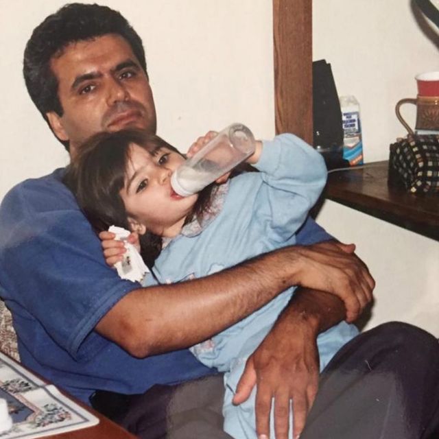  Arienne Mandi sitting in her father's lap when she was just two years old